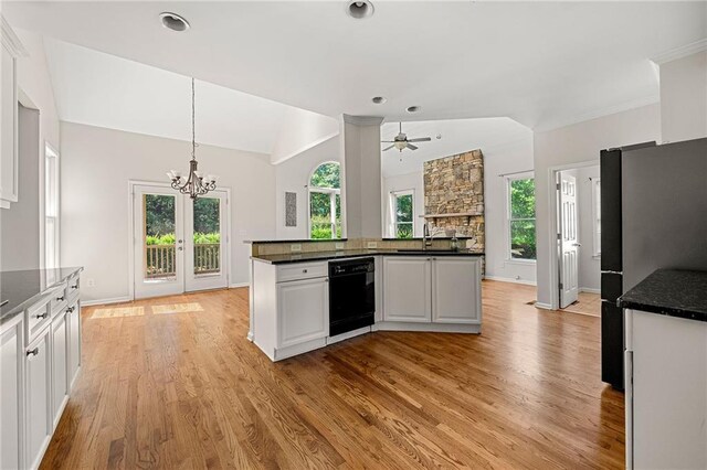 4440 Green Summers Dr, Cumming, GA 30028 - kitchen featuring black dishwasher, freestanding refrigerator, lofted ceiling, light wood-style flooring, and a chandelier