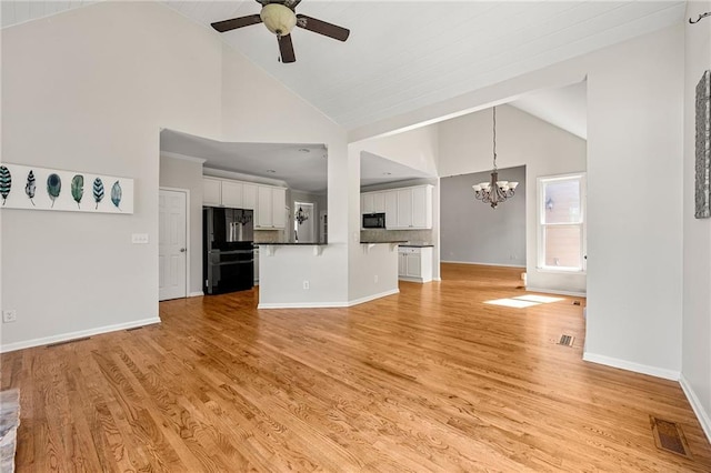 4440 Green Summers Dr, Cumming, GA 30028 - unfurnished living room with a ceiling fan, a chandelier, high vaulted ceiling, and light wood finished floors