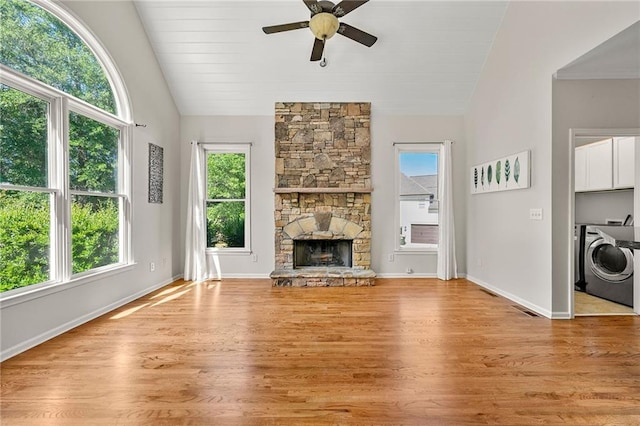 4440 Green Summers Dr, Cumming, GA 30028 - unfurnished living room with washer / dryer, vaulted ceiling, healthy amount of natural light, ceiling fan, and a fireplace