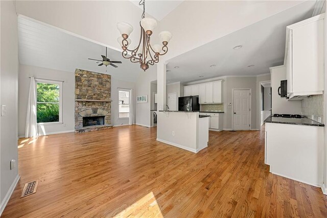 4440 Green Summers Dr, Cumming, GA 30028 - kitchen featuring open floor plan, dark countertops, a chandelier, backsplash, and black appliances