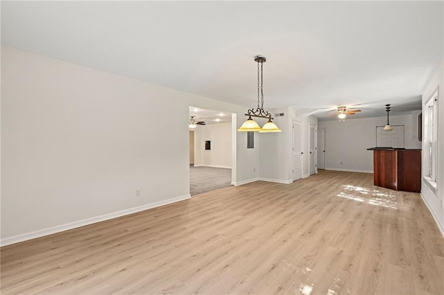 4440 Green Summers Dr, Cumming, GA 30028 - unfurnished living room featuring a ceiling fan, light wood-style flooring, and baseboards