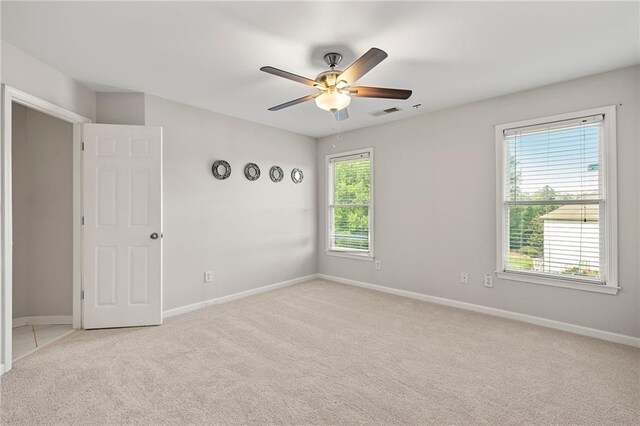 4440 Green Summers Dr, Cumming, GA 30028 - empty room featuring light colored carpet, healthy amount of natural light, and ceiling fan