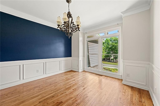 4440 Green Summers Dr, Cumming, GA 30028 - empty room featuring a chandelier, ornamental molding, a wainscoted wall, wood finished floors, and a decorative wall