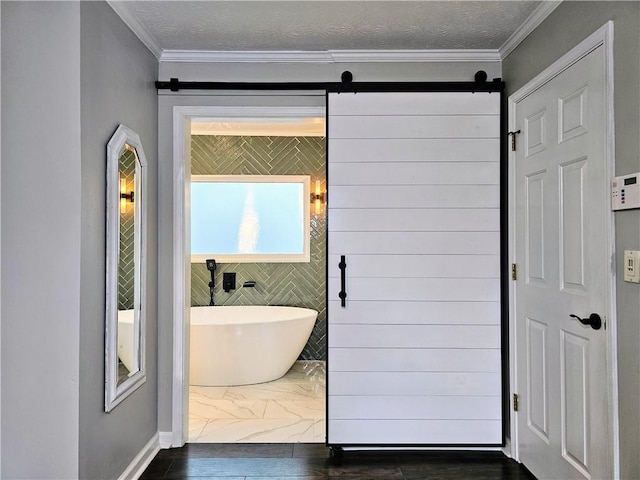 bathroom with a soaking tub, wood finished floors, crown molding, and a textured ceiling