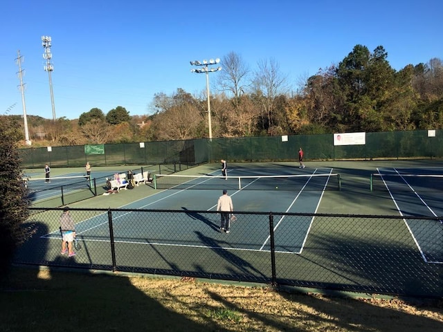 view of sport court featuring fence