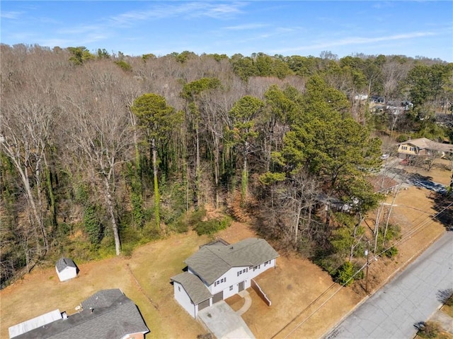 drone / aerial view with a wooded view