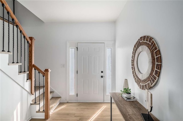 foyer entrance featuring light wood-type flooring and stairs