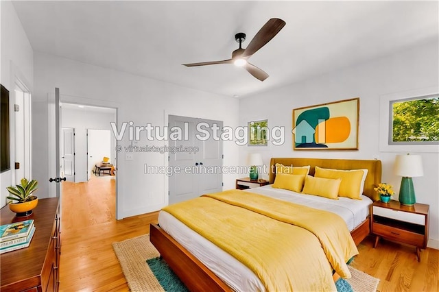 bedroom with a ceiling fan and light wood-style floors