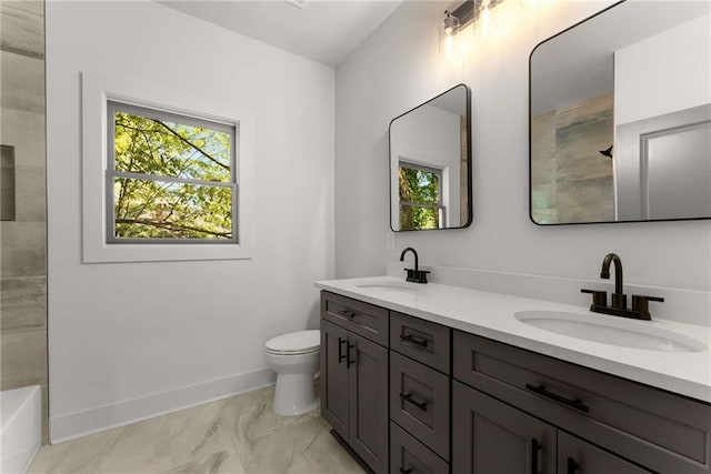 bathroom with marble finish floor, a sink, toilet, and baseboards