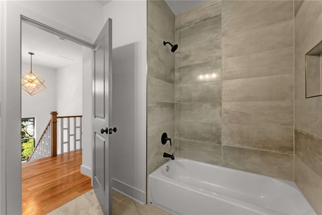 full bathroom with wood finished floors, baseboards, and shower / bathtub combination