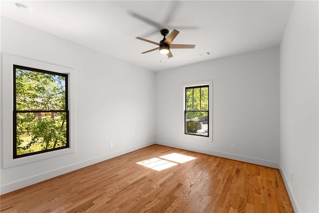 unfurnished room featuring visible vents, ceiling fan, light wood-style flooring, and baseboards