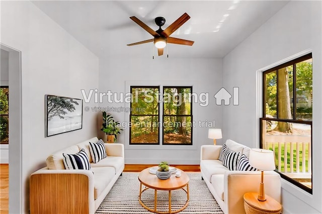 living room with ceiling fan and wood finished floors