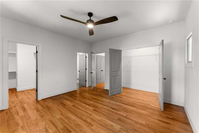 unfurnished bedroom featuring ceiling fan, a closet, light wood-type flooring, and baseboards