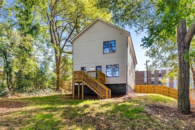 back of house featuring stairs, fence, and a wooden deck