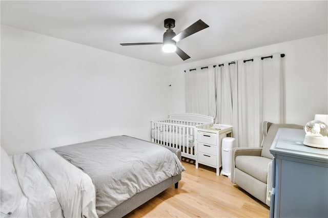 bedroom with light hardwood / wood-style floors and ceiling fan