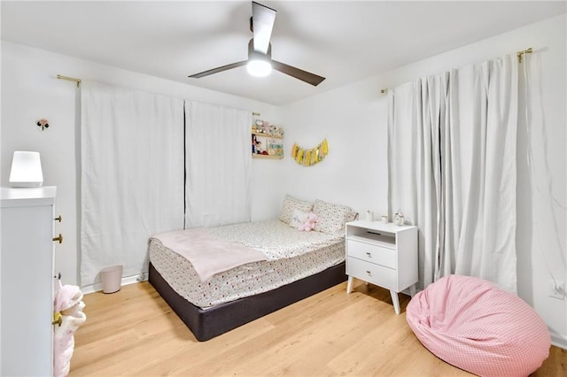 bedroom with wood-type flooring and ceiling fan