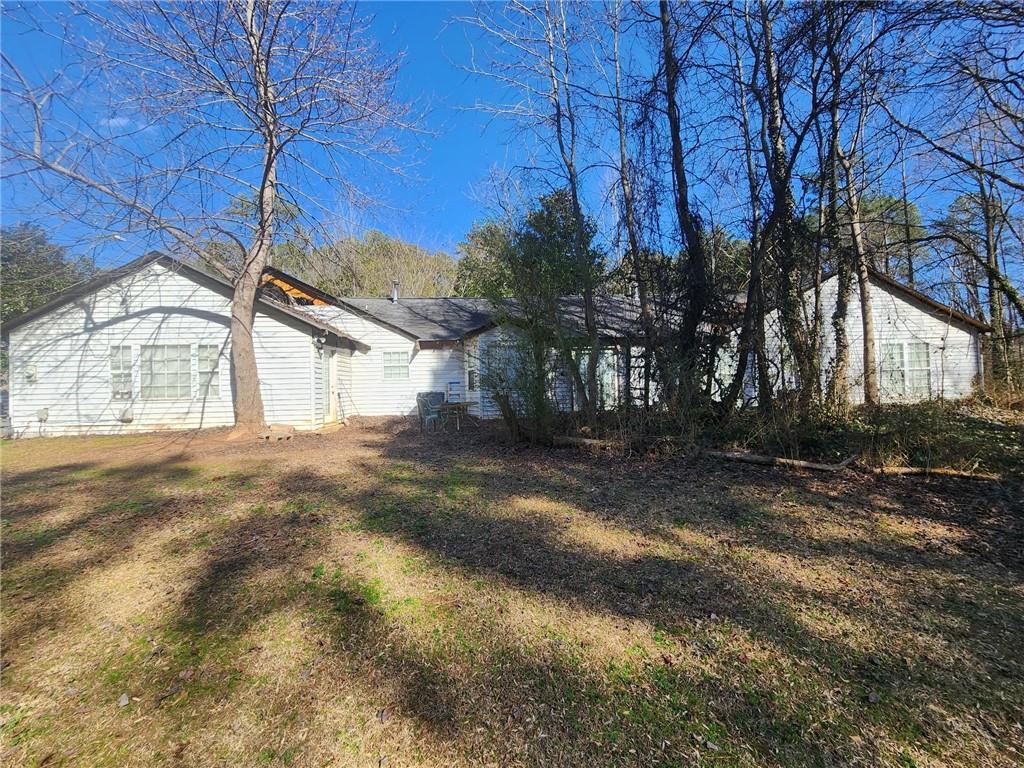 view of side of home with a lawn