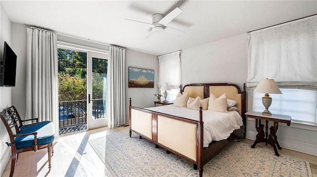 bedroom with light hardwood / wood-style flooring, access to exterior, and ceiling fan