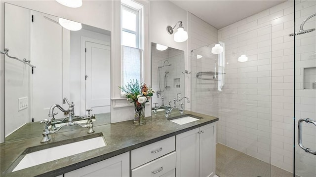 bathroom with vanity and a shower with door