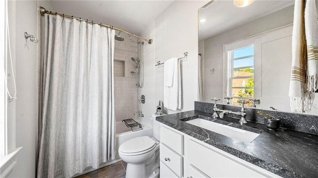 full bathroom featuring vanity, shower / bath combination with curtain, and toilet