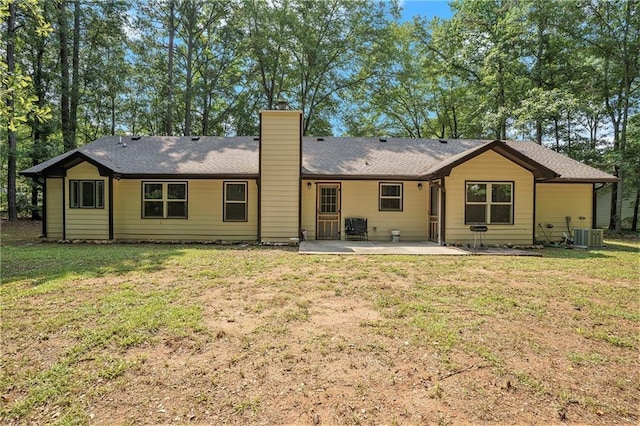 225 Hardwood Dr, Covington, GA 30016 - back of property featuring a patio area, a chimney, a yard, and central AC