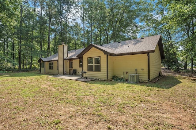 225 Hardwood Dr, Covington, GA 30016 - back of property featuring a patio area, a chimney, a yard, and central AC