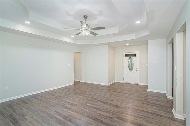 225 Hardwood Dr, Covington, GA 30016 - unfurnished room featuring a tray ceiling, ceiling fan, recessed lighting, wood finished floors, and baseboards