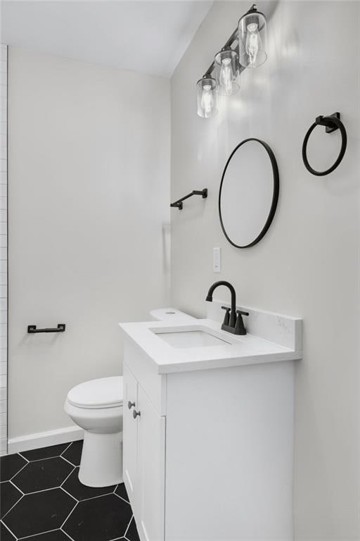 bathroom with vanity, tile patterned floors, and toilet