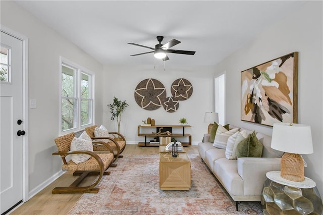 living room featuring ceiling fan and light wood-type flooring