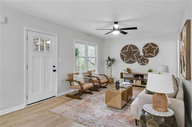 living area with ceiling fan and hardwood / wood-style floors