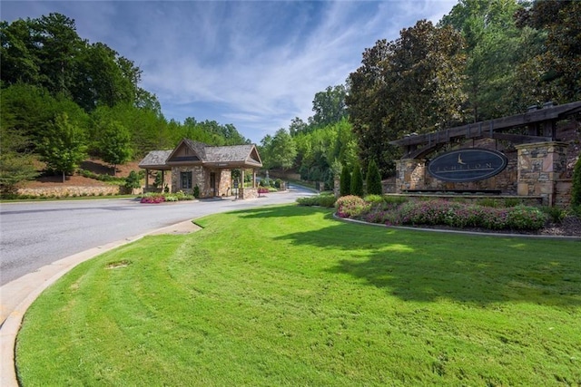 exterior space with a front yard and stone siding