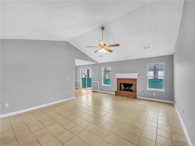 unfurnished living room featuring a healthy amount of sunlight, light tile patterned floors, ceiling fan, and visible vents