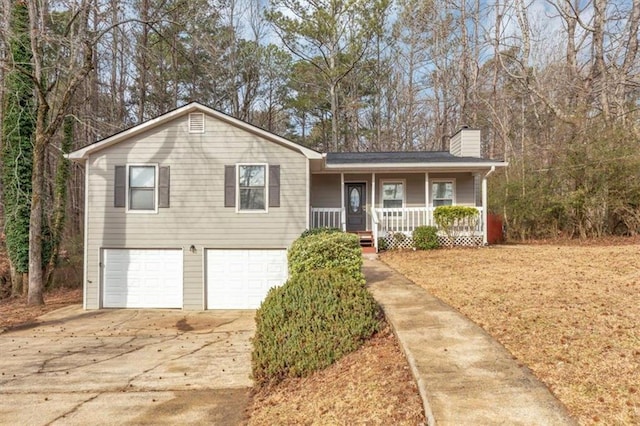 tri-level home with a porch and a garage