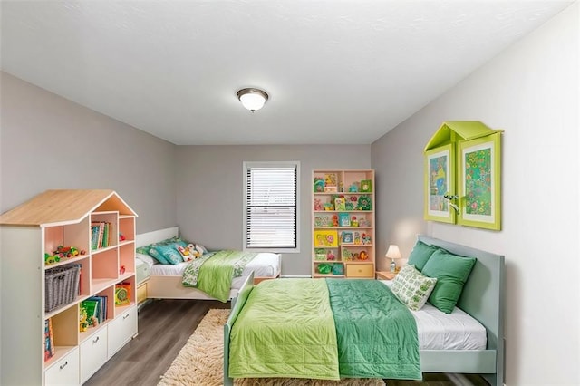 bedroom with dark hardwood / wood-style flooring