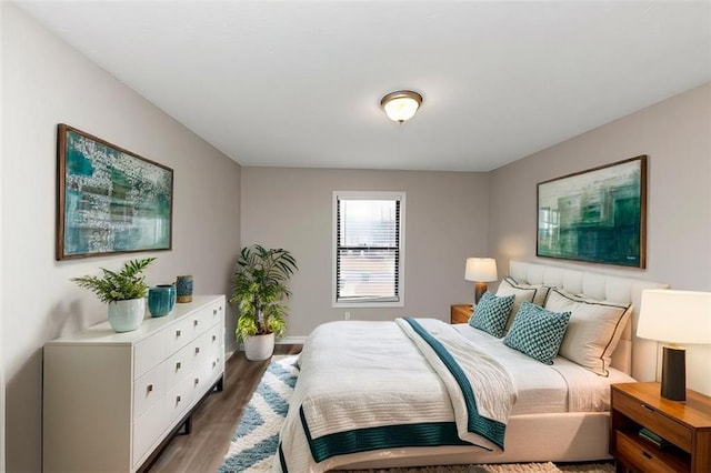 bedroom with dark wood-type flooring