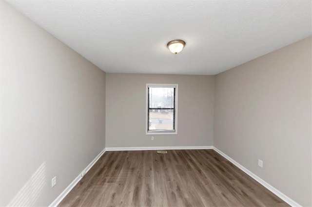 empty room featuring dark hardwood / wood-style floors