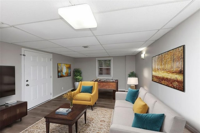 living room with hardwood / wood-style floors and a drop ceiling