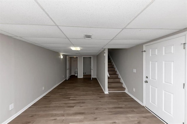 basement with hardwood / wood-style floors and a drop ceiling