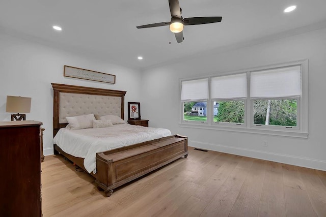 bedroom with light hardwood / wood-style floors and ceiling fan