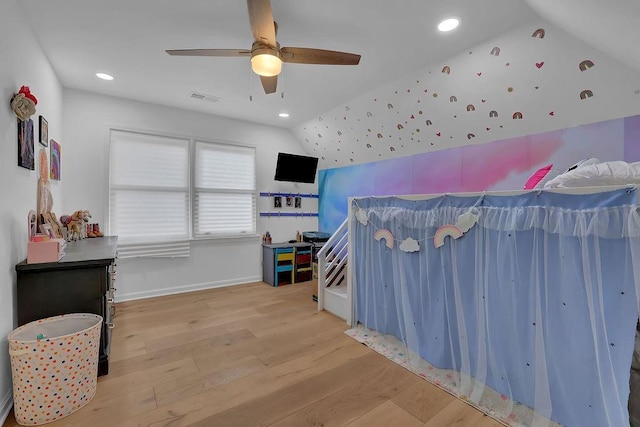 bedroom with vaulted ceiling, light hardwood / wood-style floors, and ceiling fan