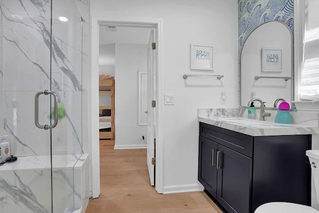 bathroom with vanity, hardwood / wood-style floors, and a shower with shower door