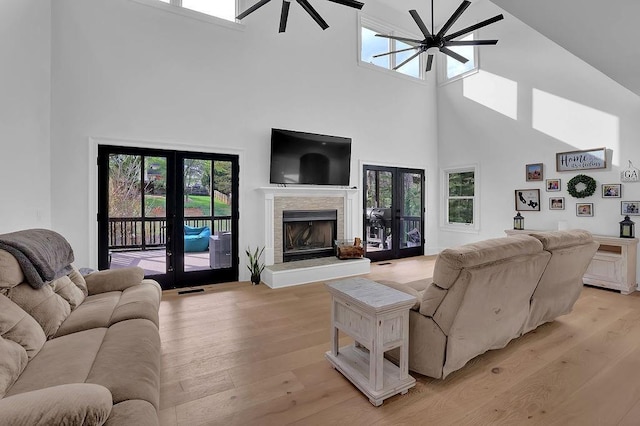 living room featuring french doors, ceiling fan, and light hardwood / wood-style floors