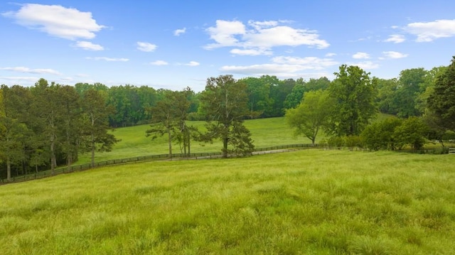 view of yard with a view of rural / pastoral area and fence