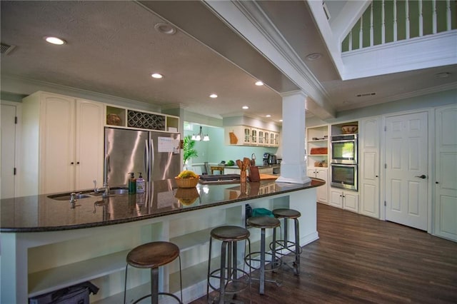1345 Quail Hollow Dr, Hamilton, GA 31811 - kitchen with ornamental molding, dark wood finished floors, open shelves, stainless steel appliances, and ornate columns
