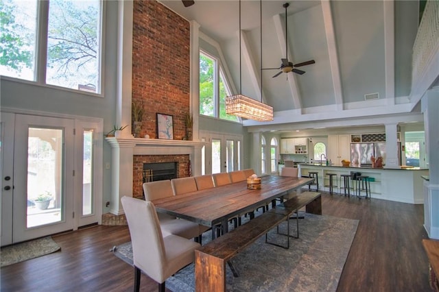 1345 Quail Hollow Dr, Hamilton, GA 31811 - dining area featuring wood finished floors, french doors, high vaulted ceiling, a brick fireplace, and ceiling fan