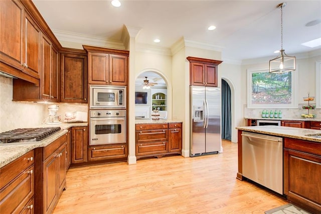 kitchen with decorative backsplash, light hardwood / wood-style flooring, light stone countertops, and stainless steel appliances