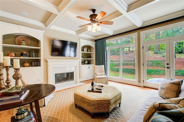 interior space with built in features, beam ceiling, and coffered ceiling