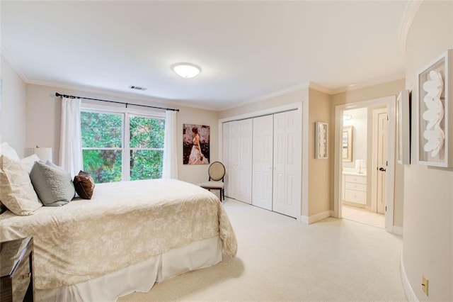 bedroom featuring light carpet, a closet, ensuite bathroom, and crown molding