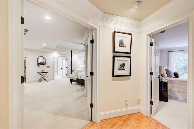 hallway with carpet flooring and crown molding