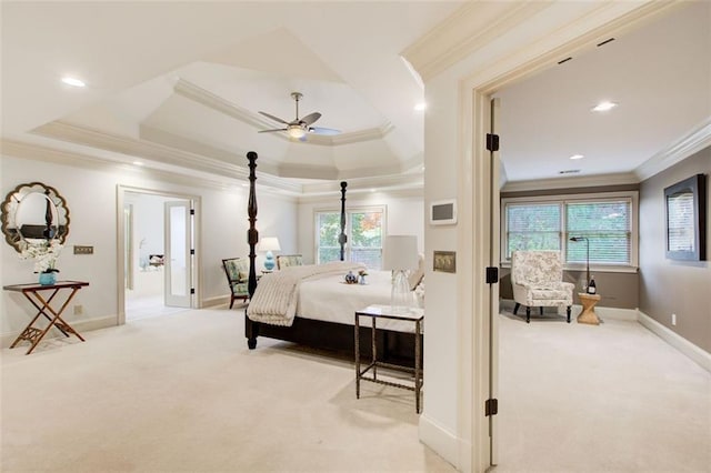 bedroom featuring ornamental molding, light colored carpet, ceiling fan, and a raised ceiling